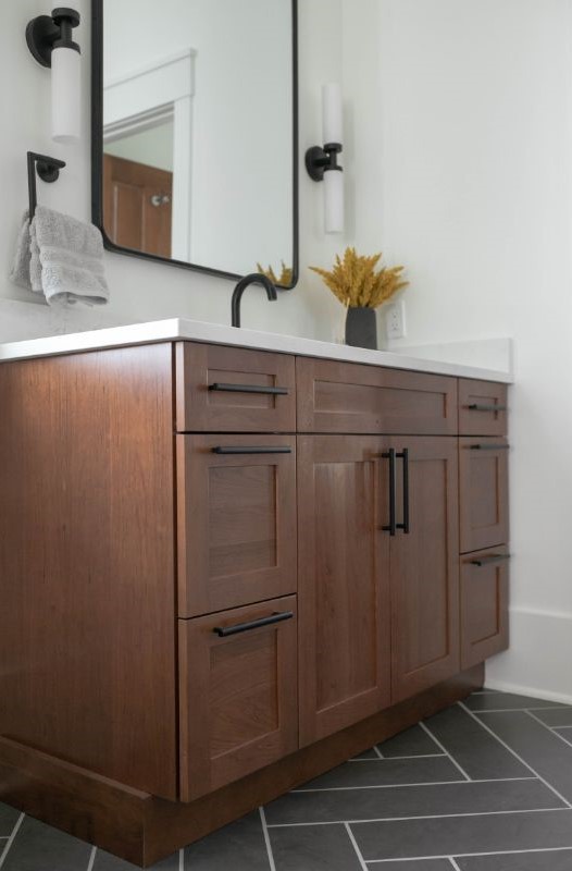 Custom wood cabinetry with black hardware sink