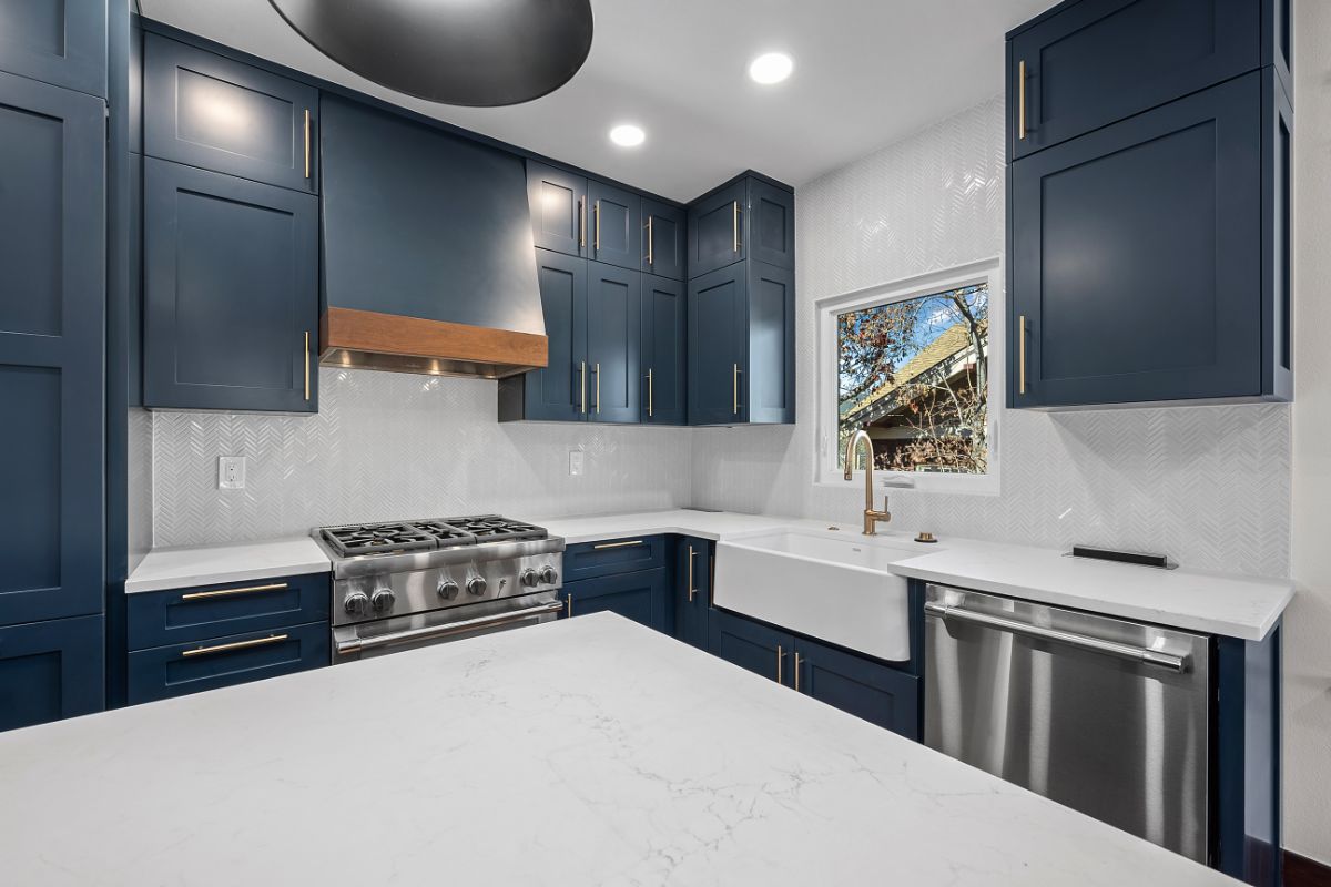 Custom white kitchen countertops and blue cabinets