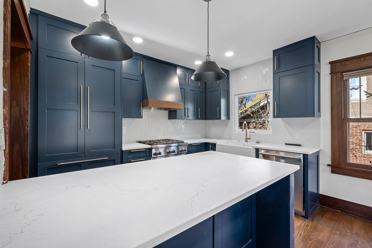 New white kitchen countertops and blue cabinetry