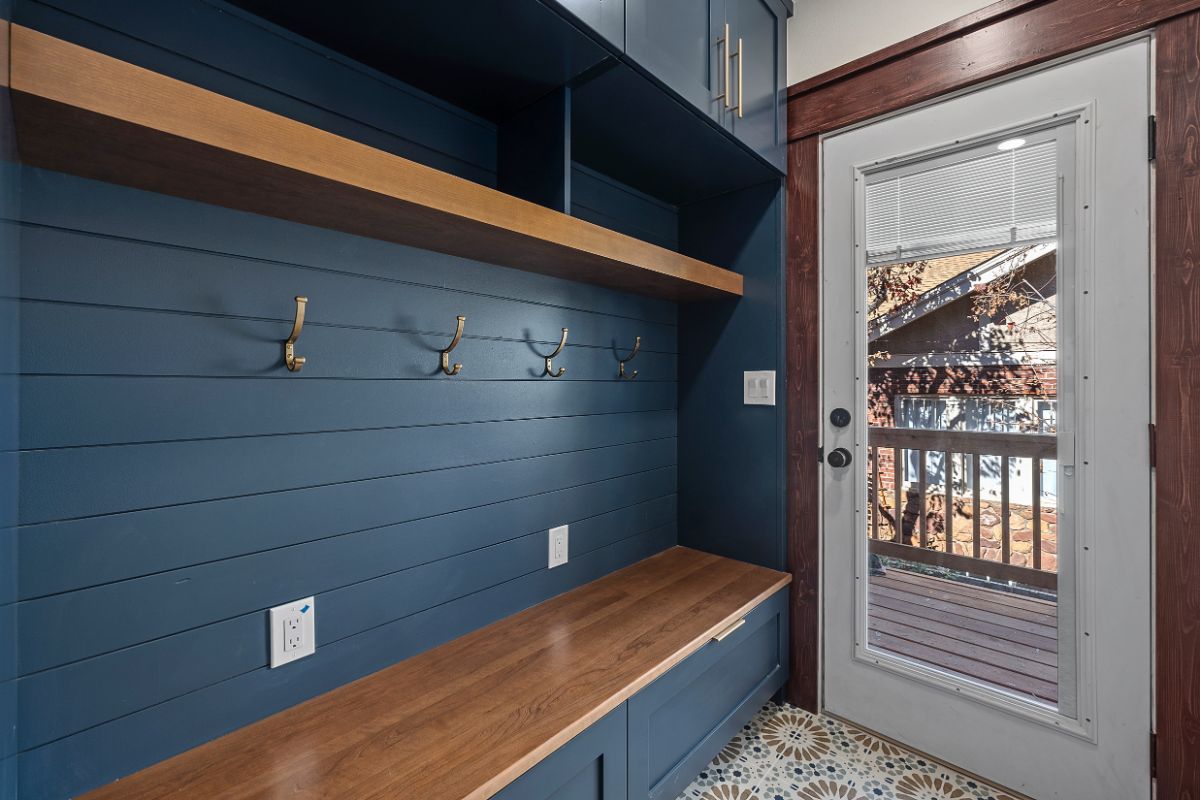 Custom blue wooden mud room and cabinet design in Longmont