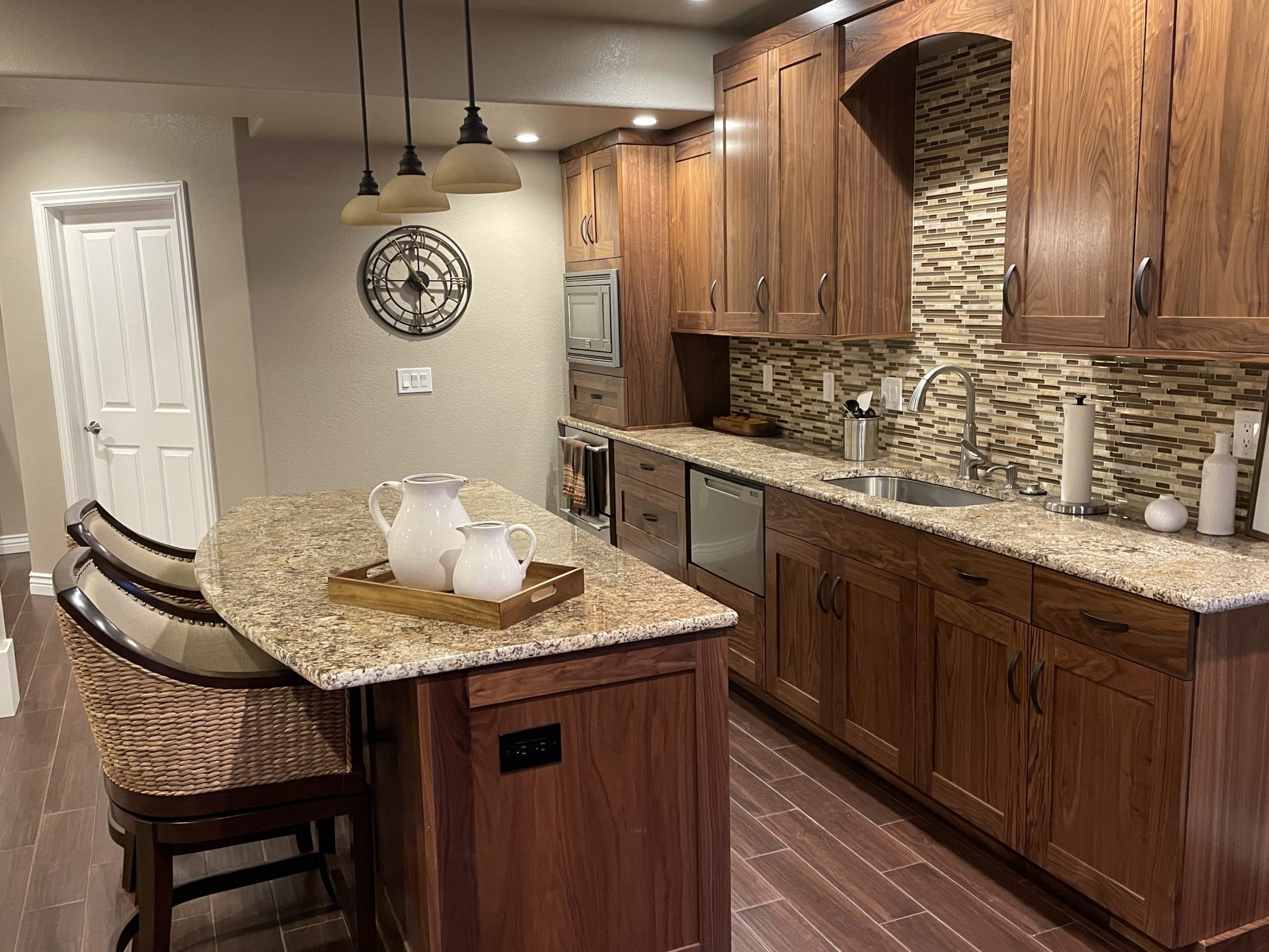 Granite countertops with custom wood cabinets and kitchen island.